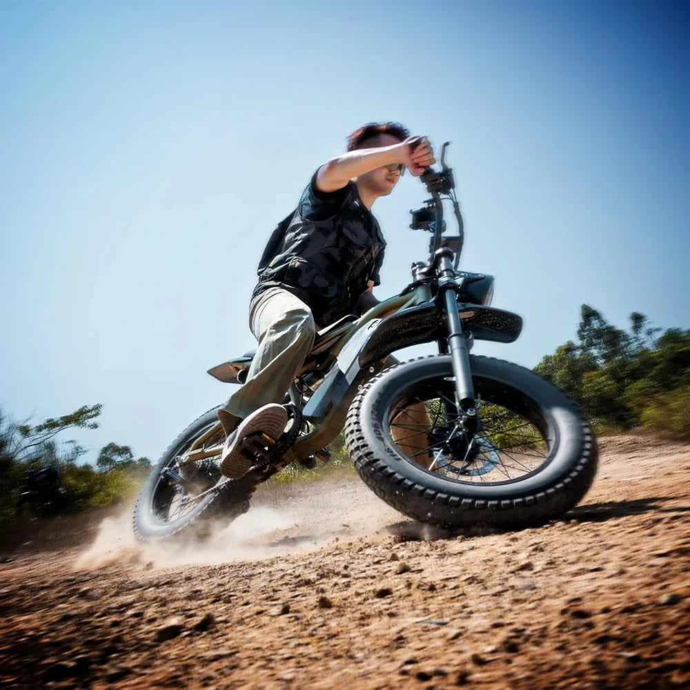 Person riding a dirt bike on a dirt path with a clear blue sky in the background