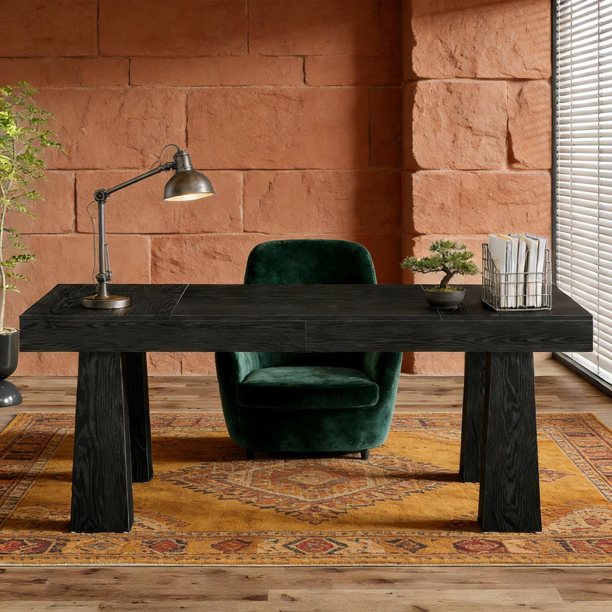 Dark wooden table with a lamp, green chair, and decorative items 